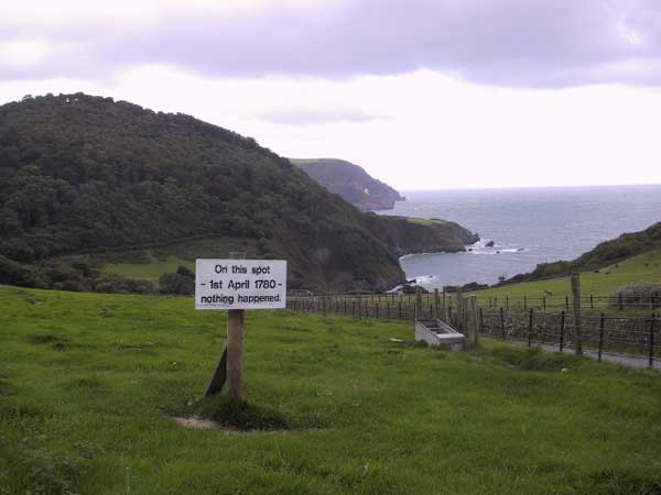 Cliff coast, wiuth sign: On this spot, 1st April 1780, nothing happened