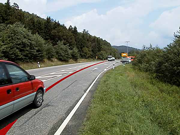 Road with a long red line sketched on it